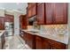 Modern kitchen featuring stainless steel appliances and wood cabinetry at 8074 Wiltshire Dr, Port Charlotte, FL 33981