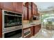 Modern kitchen with stainless steel appliances and custom wood cabinets at 8074 Wiltshire Dr, Port Charlotte, FL 33981