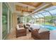 Relaxing patio with wicker furniture and pool view at 8074 Wiltshire Dr, Port Charlotte, FL 33981