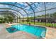 Spacious screened pool with travertine decking at 8074 Wiltshire Dr, Port Charlotte, FL 33981