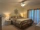 Spacious main bedroom with ample natural light and ceiling fan at 8050 Memory Ln # 101, Rotonda West, FL 33947