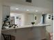 Kitchen features a breakfast bar, white cabinetry, and a view into the dining area at 8050 Memory Ln # 101, Rotonda West, FL 33947