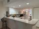 Kitchen with white cabinets and breakfast bar at 8050 Memory Ln # 101, Rotonda West, FL 33947