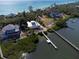 Aerial view of waterfront homes with docks, lush greenery, and beautiful coastal scenery at 6895 Manasota Key Rd, Englewood, FL 34223