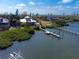 Expansive aerial view featuring a waterfront estate with a dock, lush greenery, and breathtaking water views at 6895 Manasota Key Rd, Englewood, FL 34223