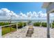 Back porch features tile flooring, seating, and a waterfront view at 6895 Manasota Key Rd, Englewood, FL 34223