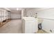A basement featuring a sink, ample counter space, and shelving offers a functional area for various tasks at 6895 Manasota Key Rd, Englewood, FL 34223