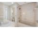 Relaxing bathroom featuring a tiled shower/tub combo and separate sink with a toilet in an adjoining room at 6895 Manasota Key Rd, Englewood, FL 34223