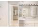 Bathroom with double sinks, a large mirror, and a view into the shower in the adjoining bathroom at 6895 Manasota Key Rd, Englewood, FL 34223