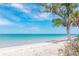 Serene beach with turquoise waters and a cloud-dotted sky, showcasing an idyllic coastal panorama at 6895 Manasota Key Rd, Englewood, FL 34223