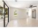 Spacious bedroom with tiled floors, neutral walls, ceiling fan and sliding glass doors to outdoor space at 6895 Manasota Key Rd, Englewood, FL 34223