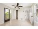 Bedroom with tile floors and doors leading to back porch at 6895 Manasota Key Rd, Englewood, FL 34223