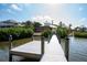 Wooden dock with pilings extending into the bay with houses in background at 6895 Manasota Key Rd, Englewood, FL 34223