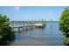 Wooden dock with pilings extending into the calm water of the bay at 6895 Manasota Key Rd, Englewood, FL 34223