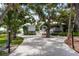 Waterfront home featuring a long driveway, and beautiful mature shade trees at 6895 Manasota Key Rd, Englewood, FL 34223