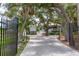 Stunning white waterfront home with a private gate, lush landscaping, and inviting architecture at 6895 Manasota Key Rd, Englewood, FL 34223