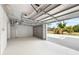 A brightly lit single car garage offers ample space for parking, storage, and home projects at 6895 Manasota Key Rd, Englewood, FL 34223