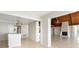 Living space featuring an adjacent kitchen area with an island and a fireplace at 6895 Manasota Key Rd, Englewood, FL 34223