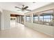 Spacious living room with tiled floors, multiple sliding glass doors leading to deck and a water view at 6895 Manasota Key Rd, Englewood, FL 34223