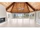Spacious living room featuring a wood ceiling, large windows with water views, and a fireplace at 6895 Manasota Key Rd, Englewood, FL 34223