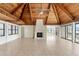 Living room with vaulted wood ceilings, a fireplace and multiple sliding glass doors offering plenty of light at 6895 Manasota Key Rd, Englewood, FL 34223