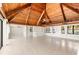 Open-concept living area boasting wood ceilings, tile floors, a fireplace, and ample natural light at 6895 Manasota Key Rd, Englewood, FL 34223