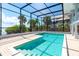 Screened pool area with brick pavers, steps, and ladder, with views of the backyard and house at 6895 Manasota Key Rd, Englewood, FL 34223
