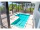 Screened pool area with brick pavers, steps, and ladder, surrounded by tropical landscaping at 6895 Manasota Key Rd, Englewood, FL 34223