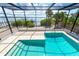 Screened pool area with river views, brick pavers, steps, and ladder at 6895 Manasota Key Rd, Englewood, FL 34223