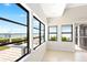 Bright sunroom with large windows showcasing waterfront view at 6895 Manasota Key Rd, Englewood, FL 34223