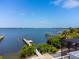 Picturesque waterfront view with private boat docks, lush greenery, and serene open water at 6895 Manasota Key Rd, Englewood, FL 34223