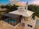 House with pool and deck at sunset at 6895 Manasota Key Rd, Englewood, FL 34223