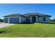 Single-story home with two-car garage and well-manicured lawn at 14361 Fort Myers Ave, Port Charlotte, FL 33981