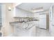 Bright white kitchen with granite countertops and stainless steel appliances at 7446 Palm Island Dr # 3514, Placida, FL 33946