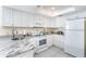 White kitchen features granite countertops and modern appliances at 7446 Palm Island Dr # 3514, Placida, FL 33946