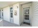 Condo entry with light gray door and white siding at 7446 Palm Island Dr # 3514, Placida, FL 33946