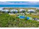 Aerial view of community with tennis court near beach at 7446 Palm Island Dr # 3514, Placida, FL 33946
