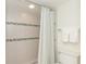 Bathroom with shower/tub combo, white tile, and updated fixtures at 7446 Palm Island Dr # 3514, Placida, FL 33946