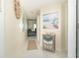 Bright entryway with tile flooring, coastal decor, and a view of the living room at 7446 Palm Island Dr # 3514, Placida, FL 33946