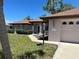 Single-story home with a two-car garage and walkway at 18122 Windswept Ave, Port Charlotte, FL 33948