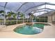 Inviting screened pool and spa with tranquil lake view at 8580 Eagle Bay Ct, North Port, FL 34287