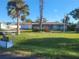 Ranch-style home with a well-maintained lawn at 745 Coral Way, Englewood, FL 34223
