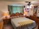 King-size bedroom with wood furniture and ceiling fan at 745 Coral Way, Englewood, FL 34223