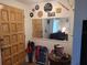 Bright entryway with wood door, mirror, and eclectic decor at 745 Coral Way, Englewood, FL 34223