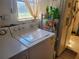 Laundry room with washer, dryer, and shelving unit at 745 Coral Way, Englewood, FL 34223