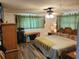 Spacious main bedroom with king-size bed and built-in wooden wardrobe at 745 Coral Way, Englewood, FL 34223