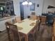 Dining area with table and chairs, adjacent to kitchen and home office at 745 Coral Way, Englewood, FL 34223