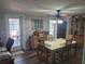 Bright dining room with table, chairs, and built-in wine rack, view to backyard at 745 Coral Way, Englewood, FL 34223