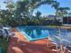 Relaxing pool area with patio furniture at 745 Coral Way, Englewood, FL 34223