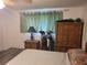 Bedroom with king-size bed, built-in wardrobe, and wood furniture at 745 Coral Way, Englewood, FL 34223